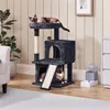 Two cats are playing on a multi-level cat tree in a living room setting. Podgląd zdjęcia produktu
