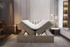 A bedroom scene with a bed that has its mattress lifted, revealing storage underneath. The room has modern decor. Produktbild-Vorschau