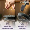 A collage showing two close-up views of a kitchen gadget being used with a food processor. The left side shows a hand holding a metal attachment, and the right side shows a black plastic tool being used to remove a part from the food processor. Produktbild-Vorschau