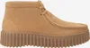 A side view of a single brown clog shoe. Voir les images du produit