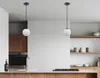 A modern kitchen with pendant lights over a counter. Produktbild-Vorschau