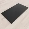 A black shower tray is placed on a light-colored wooden floor. Produktbild-Vorschau