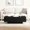A black coffee table in front of a white sofa in a living room. Produktbild-Vorschau