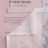 A close-up of a sheer curtain with a floral pattern and text overlay. Produktbild-Vorschau