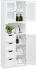 A white bathroom cabinet with glass doors and drawers, filled with toiletries and towels. Podgląd zdjęcia produktu