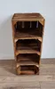 A wooden crate shelving unit with four shelves, set against a white wall and wooden floor. Produktbild-Vorschau