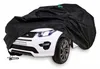 A white Land Rover toy car is partially covered by a black car cover. Produktbild-Vorschau