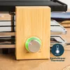 Close-up of a raclette grill's control panel with a bamboo finish and a temperature dial. Produktbild-Vorschau