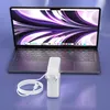 A laptop and its charger are displayed on a purple surface. Produktbild-Vorschau
