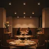 A dimly lit restaurant interior with people dining at tables. Náhled obrázku produktu