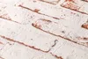 A close-up view of textured wallpaper with a brick pattern. Produktbild-Vorschau