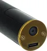 A close-up view of the bottom end of a black cylindrical device with a textured grip and a gold-colored metal cap. Náhled obrázku produktu