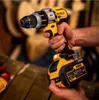 A hand holding a DeWalt cordless drill, with other tools in the background. Anteprima dell’immagine prodotto
