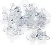A pile of clear plastic suction cups with a small hook or slot for hanging items. Produktbild-Vorschau
