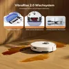 A white robot vacuum cleaner is shown on a wooden floor with spilled liquid, next to three inset images demonstrating its features. Produktbild-Vorschau