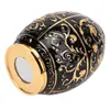 A black and gold decorative egg-shaped object, likely a toothpick holder, shown from a low angle against a white background. Náhled obrázku produktu