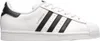 A side view of a white Adidas Superstar sneaker with black stripes and heel tab. Podgląd zdjęcia produktu