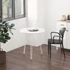 A round white dining table with a black chair next to it, in a room with a window and a cabinet. Produktbild-Vorschau