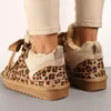 A close-up shot of a person's feet wearing leopard print sneakers. Produktbild-Vorschau