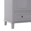 A close-up view of the bottom corner of a gray cabinet, showing its legs and a drawer. Náhled obrázku produktu