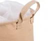 A close-up view of the top edge and handle of a beige fabric storage basket with a white liner. Produktbild-Vorschau