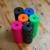 A collection of colorful Blackroll mini fascia rollers arranged on a wooden surface. Produktbild-Vorschau