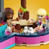 Two LEGO Friends characters are sitting in a pool area, with drinks and cherries on a table. Produktbild-Vorschau