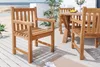 Outdoor patio furniture set with teak chairs and table on a wooden deck overlooking a beach. Produktbild-Vorschau