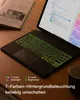 A tablet with a keyboard case is shown on a wooden desk, with a book next to it. Produktbild-Vorschau