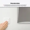 A hand is shown pressing a wall switch next to a mirror. Produktbild-Vorschau