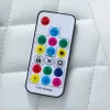 A close-up of a remote control for a gaming chair, showing various buttons and symbols. Produktbild-Vorschau