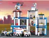 A Lego police station with vehicles and figures against a city skyline and sunset. Náhľad obrázku produktu