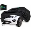 A black car cover is draped over a white toy car. Produktbild-Vorschau