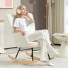 A woman is relaxing in a rocking chair, listening to music with headphones on. Náhled obrázku produktu