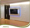 A modern living room with a TV mounted on a textured wall, featuring decorative lighting. Podgląd zdjęcia produktu