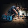 A man is using a Bosch drill to work on wooden planks in a workshop. Anteprima dell’immagine prodotto