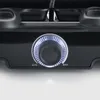 Close-up of a black raclette grill's control knob with a blue illuminated ring. Voir les images du produit