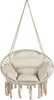 A hanging chair with cushions and fringe detail, suspended by ropes. Voir les images du produit