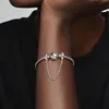 A close-up shot of a person's arm wearing a Pandora bracelet with a safety chain adorned with blue and teal beads. Anteprima dell’immagine prodotto