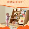 A baby is reaching for a wooden bookshelf filled with books and toys. The bookshelf is designed for children, with an optimal height for easy access. Náhled obrázku produktu