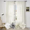 A room interior with a window covered by sheer curtains, a chair, and a lamp. Four fabric swatches are displayed in the foreground. Produktbild-Vorschau