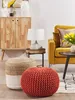 A living room scene with a yellow sofa, a wooden cabinet, a side table with a lamp, and two poufs in the foreground. Produktbild-Vorschau