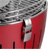 A close-up of a red charcoal grill, showing a metal clasp and the grill grate. Podgląd zdjęcia produktu