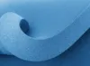 A close-up shot of a rolled-up piece of blue foam material. Náhľad obrázku produktu