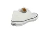 A white low-top sneaker is shown from the back-side, isolated on a white background. Produktbild-Vorschau
