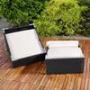 Two pieces of outdoor furniture with beige cushions are placed on a wooden deck, with lush green bushes in the background. Anteprima dell’immagine prodotto