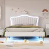 A white upholstered bed frame with a crown-shaped headboard and LED lighting, set in a child's bedroom. Anteprima dell’immagine prodotto