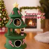 A Christmas tree-shaped cat tree with two cats, set in a festive living room with a fireplace and Christmas tree. Anteprima dell’immagine prodotto