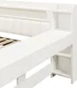 A close-up view of a white bed frame with built-in shelving and a padded headboard. Produktbild-Vorschau