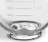 Close-up of a glass measuring bowl with clear markings for volume. Voir les images du produit